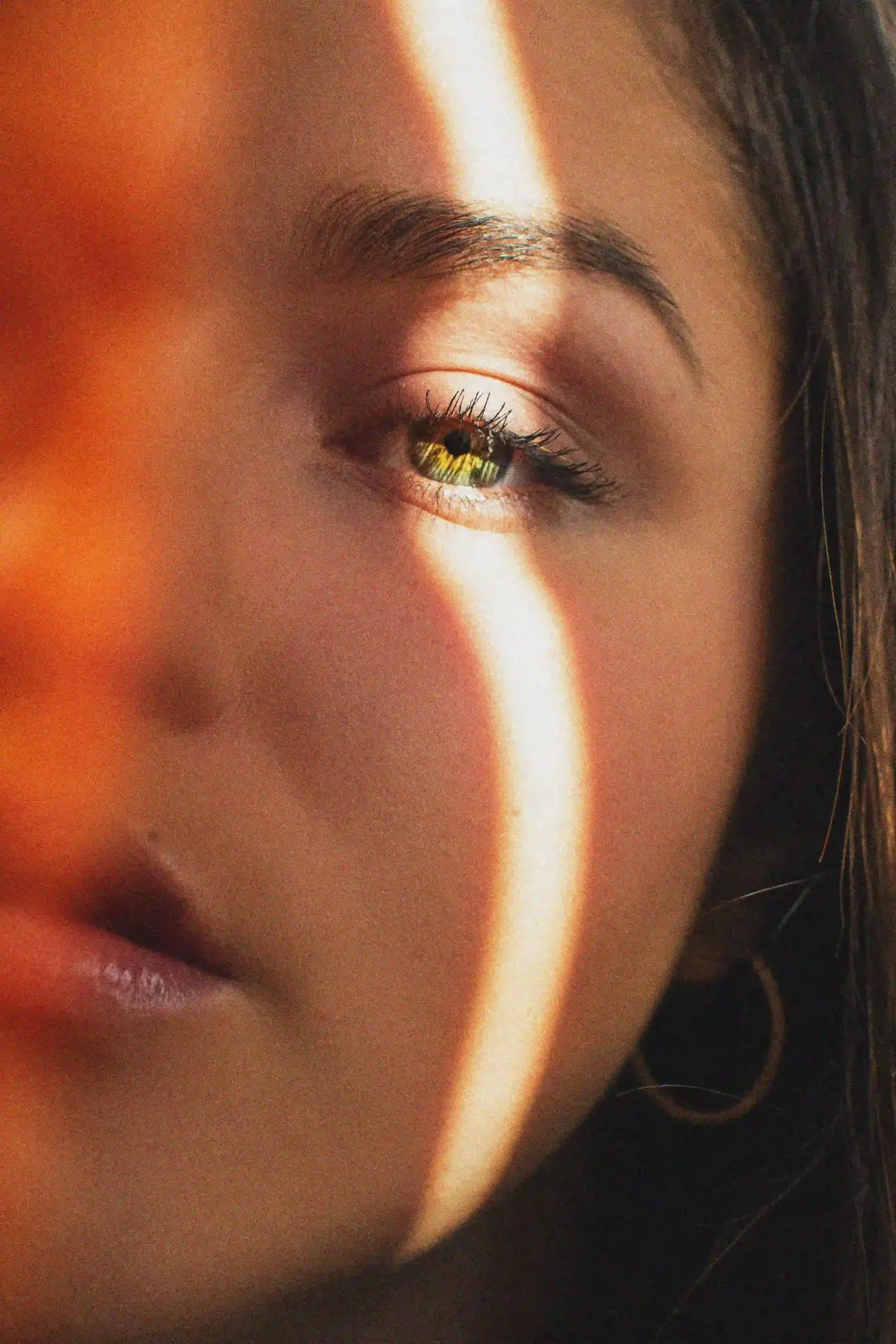 A woman with brown eyes and a yellow eye, showcasing a unique and intriguing contrast in her gaze.