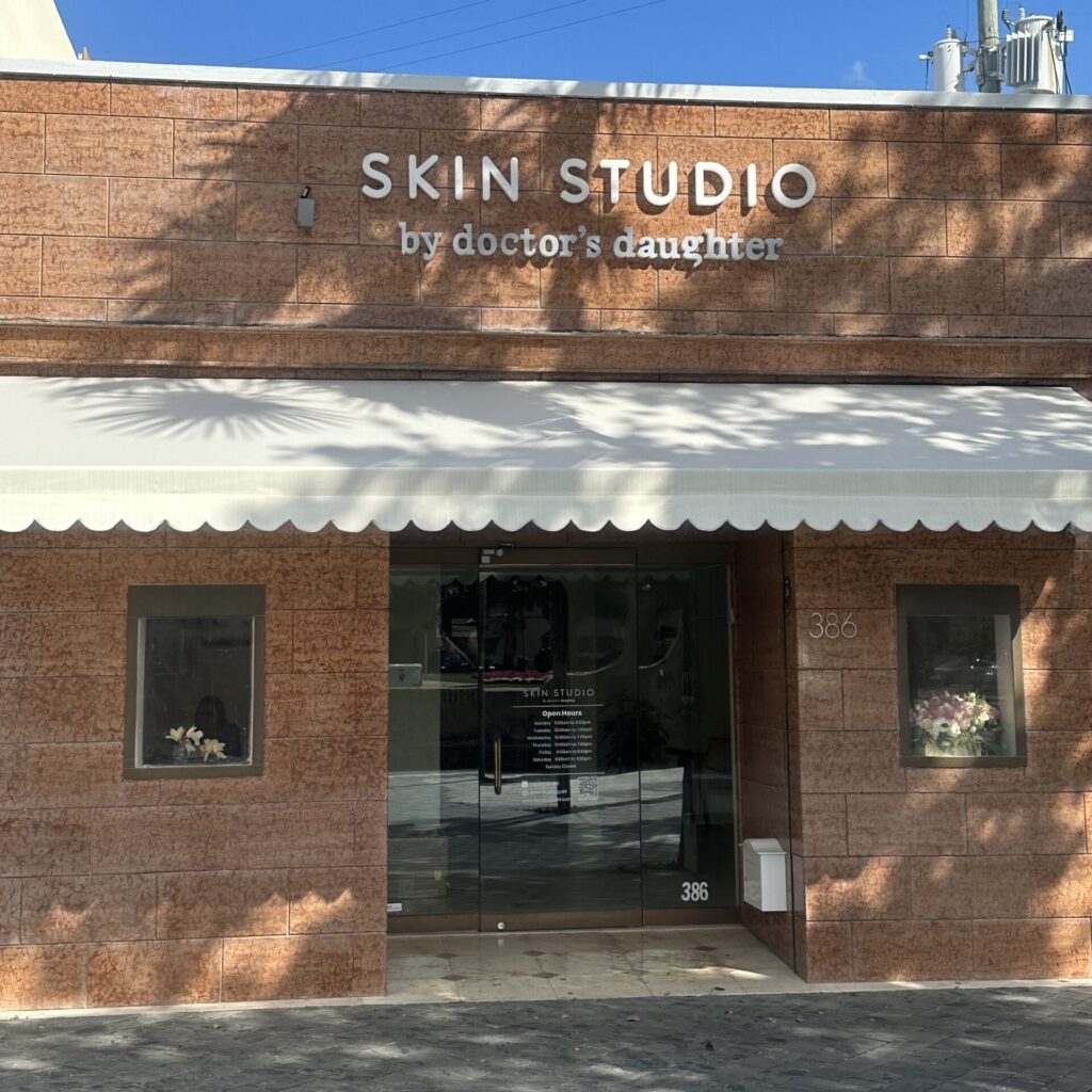 Front view of Skin Studio by Doctor’s Daughter with brick façade and white awning.