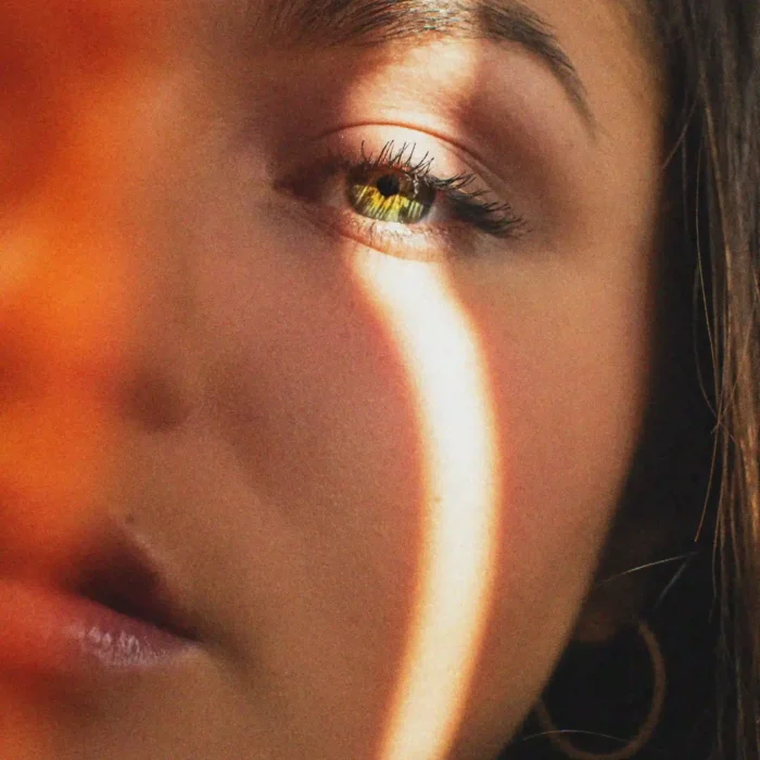 A woman with brown eyes and a yellow eye, showcasing a unique and intriguing contrast in her gaze.
